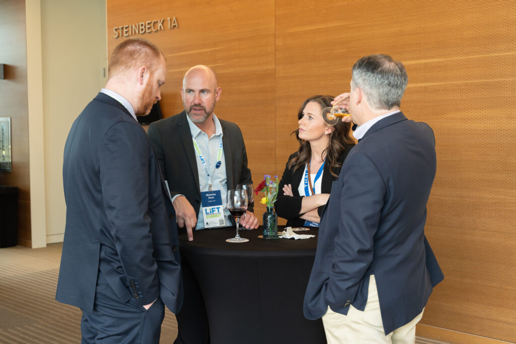 Attendees in conversation at a networking reception during the LIFT Summit