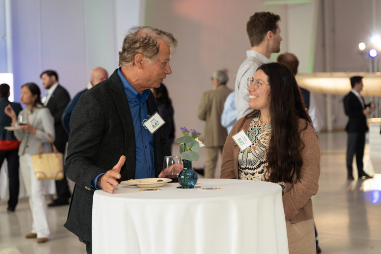 Guests networking at a high-top table during the LIFT Summit Opening Reception